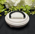 black beaded bracelet says "enjoy the journey"