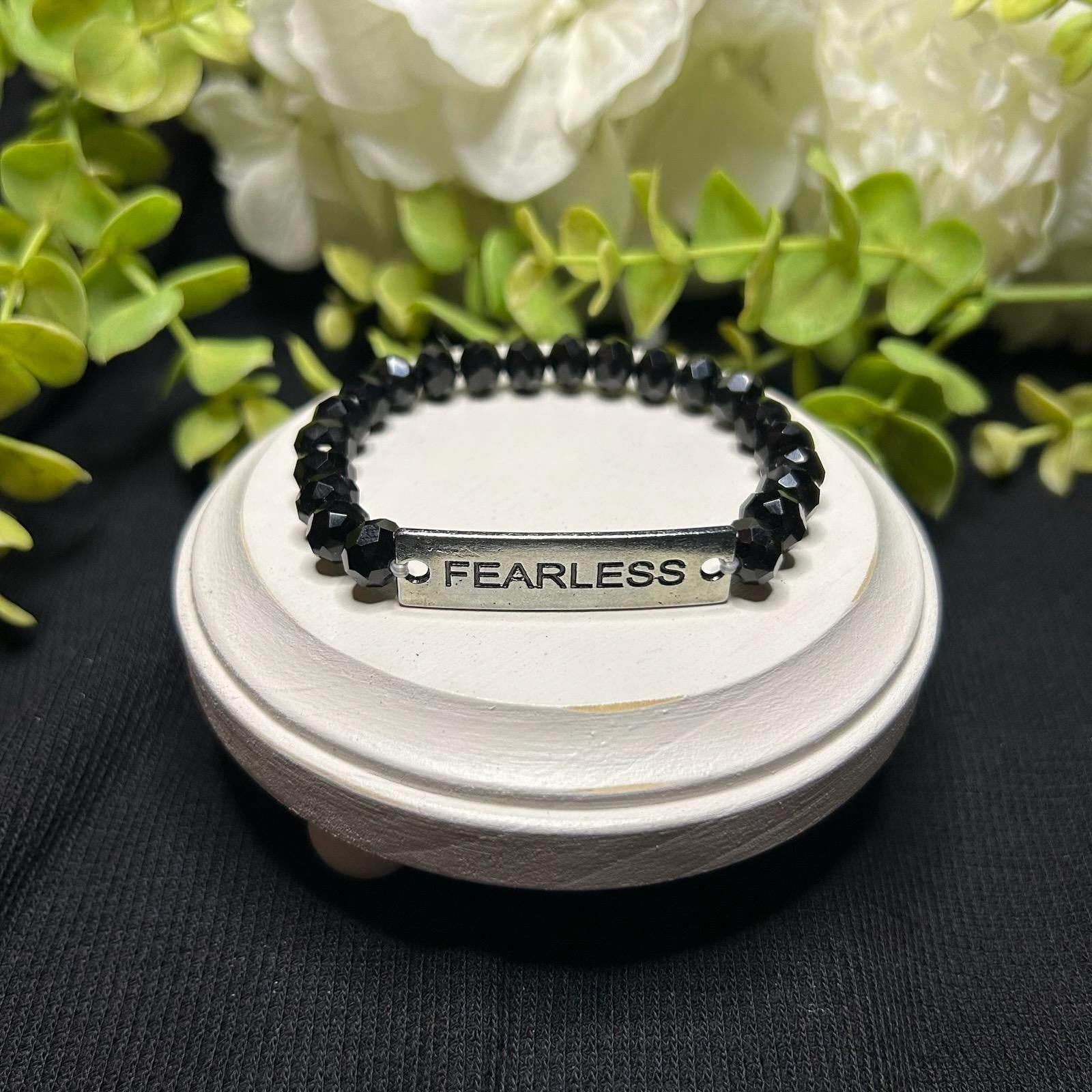 black beaded bracelet says "FEARLESS"