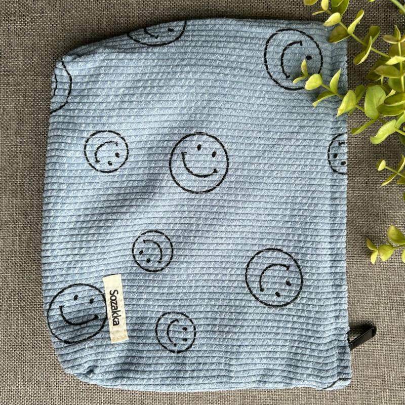 blue corduroy bag with smiley faces